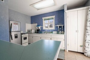 Fridge, microwave, coffee/tea maker, cookware/dishes/utensils