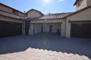 A residential property with two garages, a paved driveway, and a tiled roof. - Condo 25-1 Luxury Villa - Golf Course Views | El Dorado Ranch | San Felipe (San Felípe)