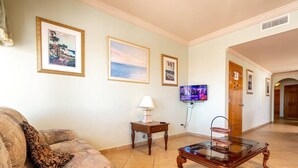 A living room with a sofa, a coffee table, a lamp, and framed pictures on the wall. - Jerry`s Beach Club Condo 2 (San Felipe)