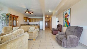 A spacious living room with a sofa set, a recliner, and a painting on the wall.