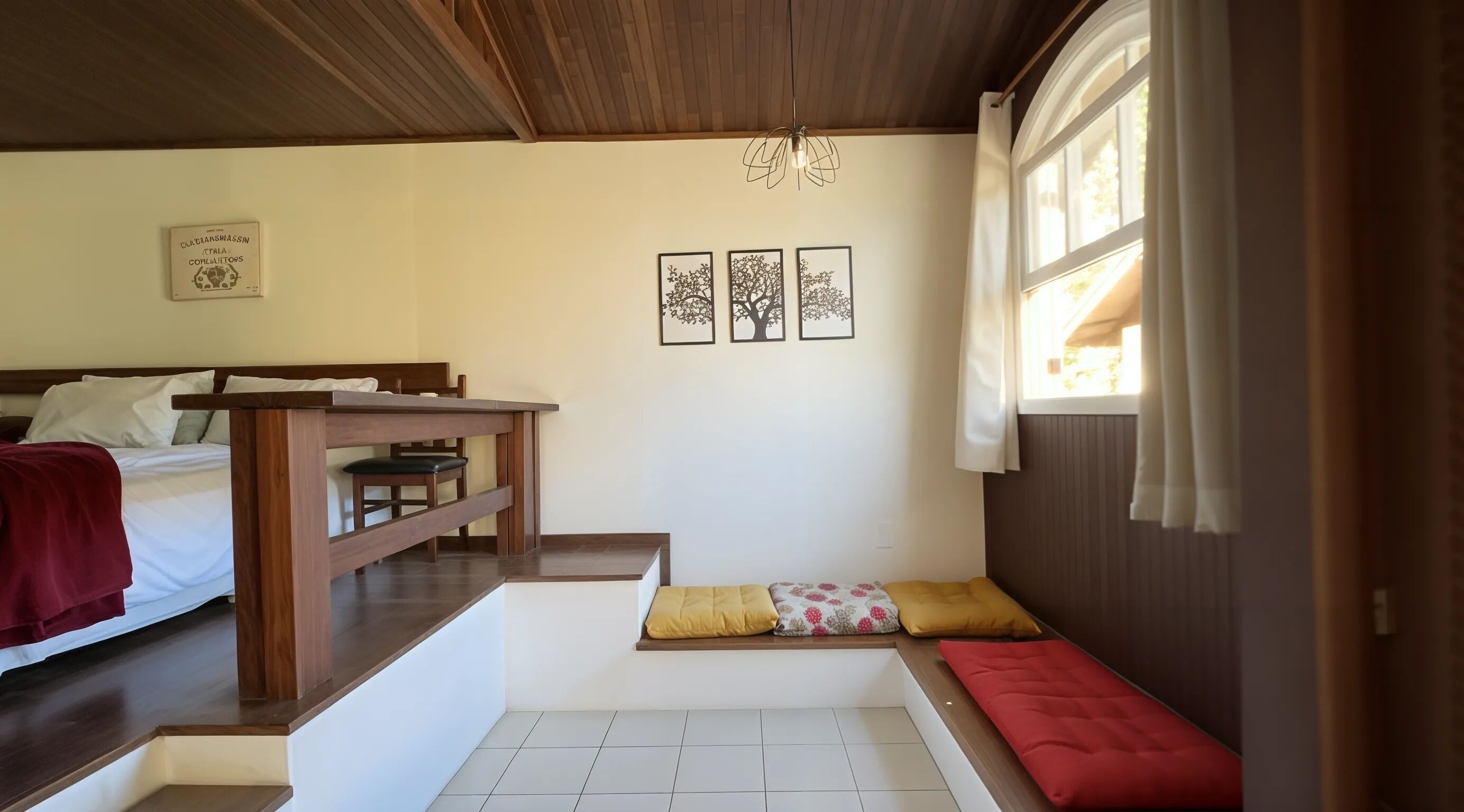 A room with a bunk bed, a desk, a bench with cushions, and a window with curtains.