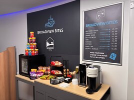 A snack bar area with a menu board listing items like Nespresso coffee and Yorkshire tea.