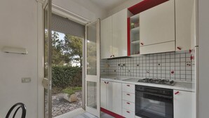 A kitchen with white cabinets, a gas stove, and a built-in oven.