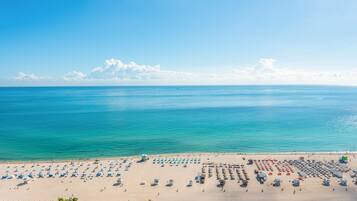 On the beach, sun-loungers, beach towels