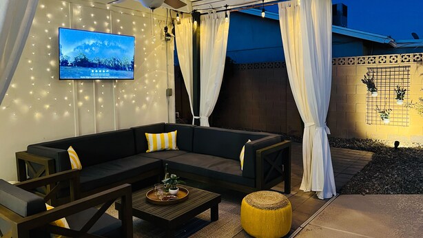 An outdoor seating area with a sofa, chairs, a coffee table, and a ceiling fan. - Cabana Retreat | Amazing Poolside Getaway (Tempe)
