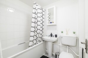 Bathtub, hair dryer, towels, soap