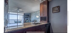 Enjoy a meal with a view from the kitchen, which offers a balcony with a chair and table.