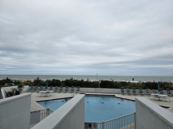 Relax by the ocean with a refreshing swim in our rooftop pool surrounded by lounge chairs and umbrellas.