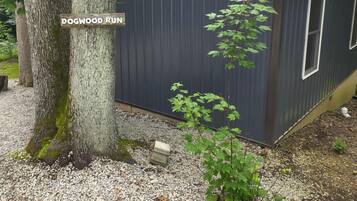 A building labeled 'DOGWOOD RUN' with a gravel ground and a tree in the foreground.