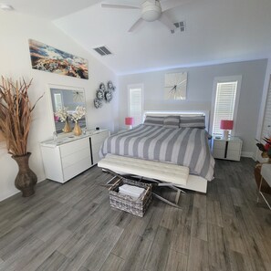 Relax in this serene bedroom with a comfortable bed, bedside table, and dresser.