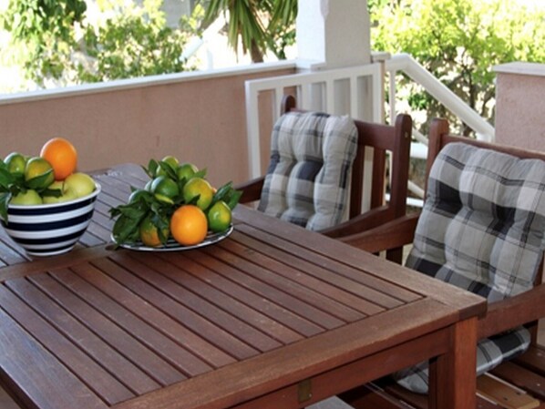 Enjoy a casual meal or relax with a refreshing drink at this outdoor dining area, featuring a table and two chairs.