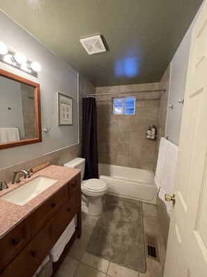Bathtub, hair dryer, towels, soap