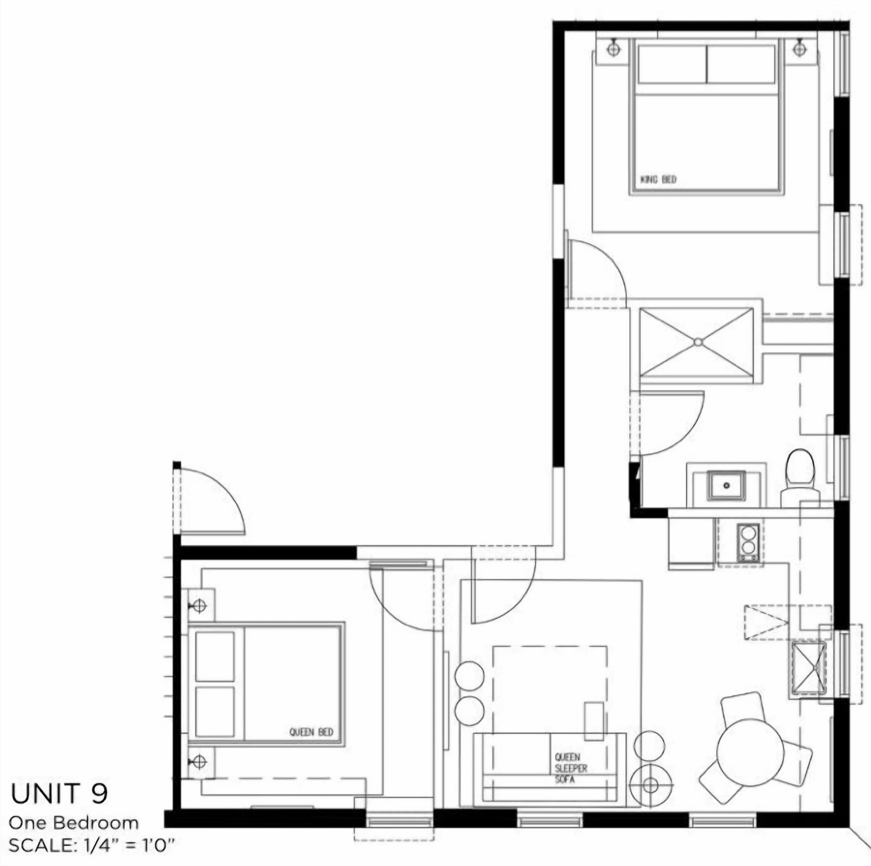 Un appartement d’une chambre comprenant un lit double, une kitchenette, une salle de bain et un espace de vie.