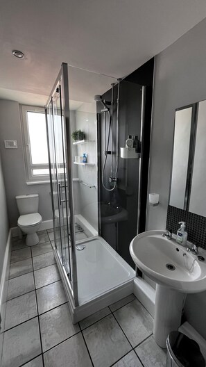 Shower, hair dryer, towels, soap