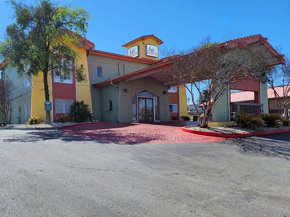 A building with a red roof and a sign reading "Flex Studios." - Flex Studios (San Antonio)
