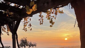A stone pathway leading to a wooden pergola with a view of a sunset over a hilly landscape. - FarmStay HillTop wine country views 6BR/4BA (Paso Robles)