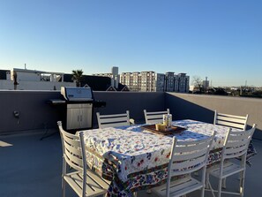 Enjoy al fresco dining on this rooftop terrace with a grill and city views.