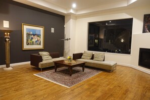 Relax in this inviting living room with a sofa, coffee table, and framed artwork.