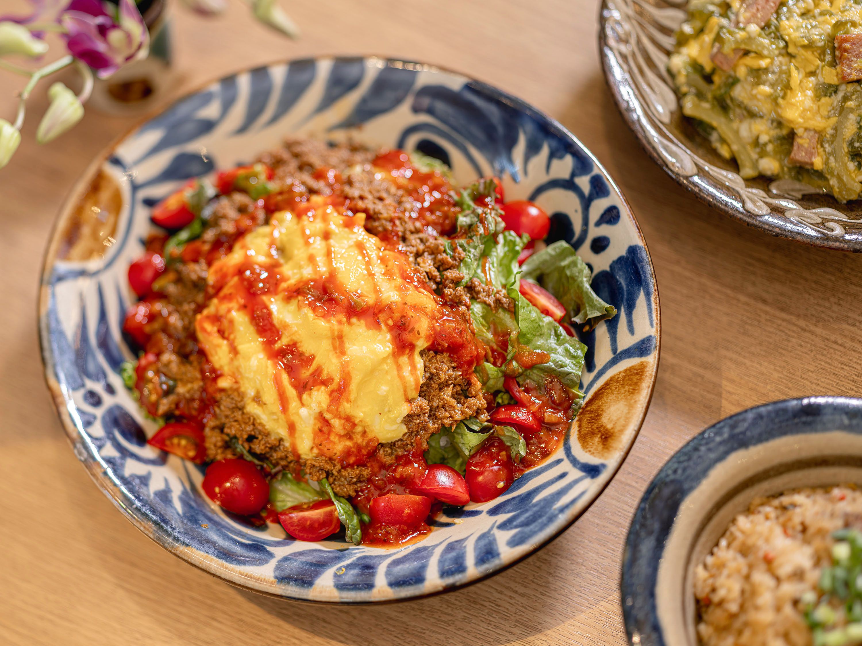 A plate of food with a patterned bowl.