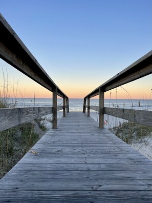 A wooden boardwalk leading to the beach with a clear sky above. - Unit 3 - Shoreline - Pet-Friendly Crescent Beach Hideaway, Walk to Beach (St. Augustine)