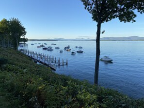 A lakeside view with docked boats and a wooden pier.