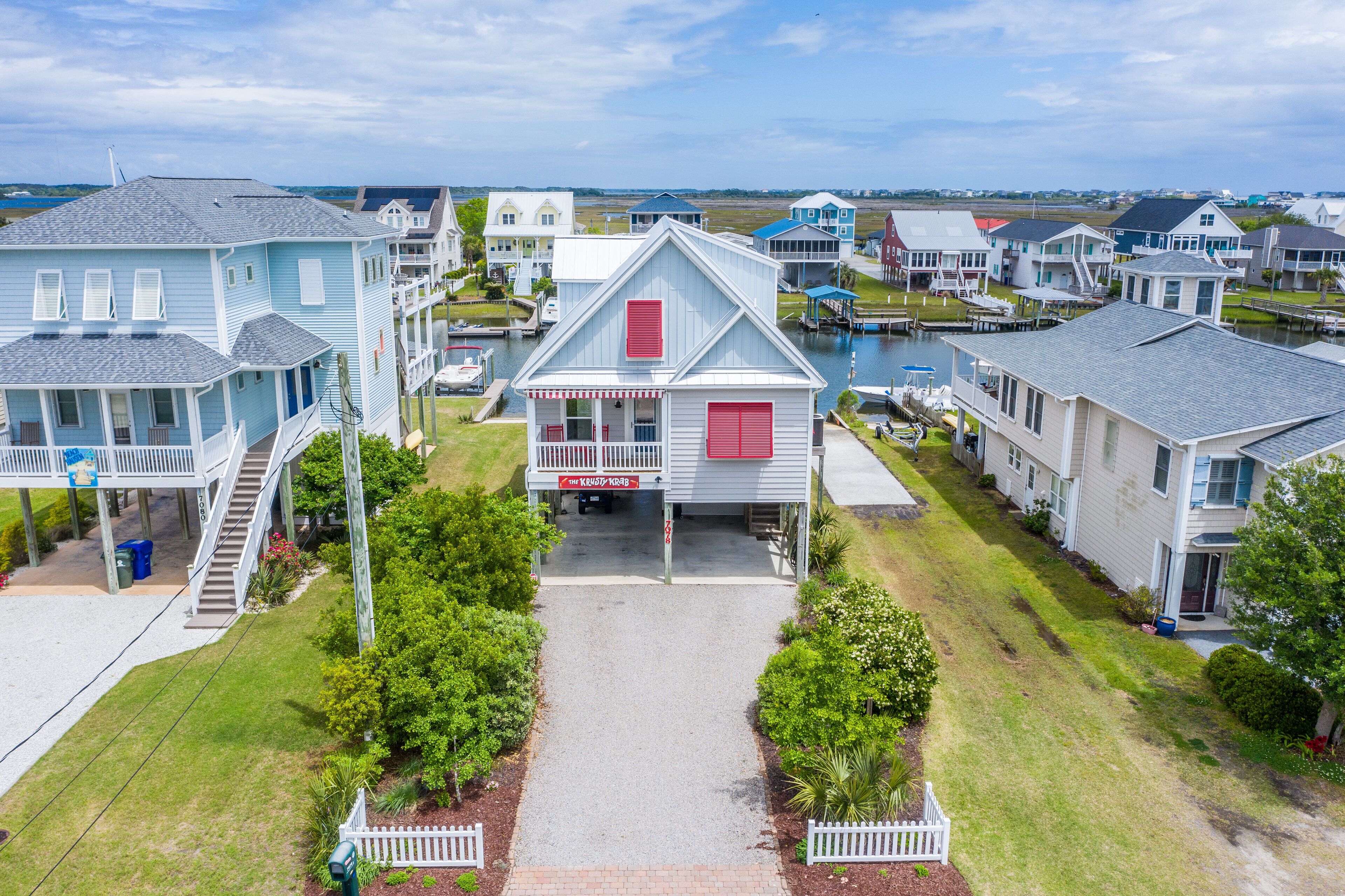 A residential area with houses, a dock, and a clear sky.