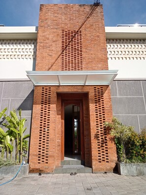 Stunning building with a grid-like brick facade and elegant entrance.