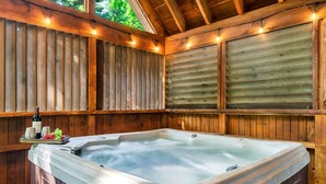 A hot tub with wooden walls and a wooden ceiling, surrounded by string lights. - Hot Tub/Close2Downtown/Nearby Fishing Pond (Sevierville)
