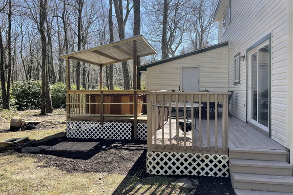 Backyard has a firepit, covered hottub and room to enjoy the outdoor space