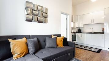 Deluxe Apartment | Living area | 32-inch flat-screen TV with digital channels, TV