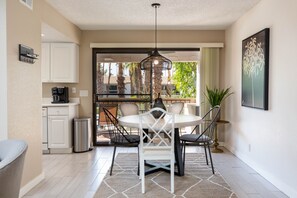 A compact kitchen with white cabinets, a coffee machine, and a trash can. - 1BR Palm Springs Retreat - Golf, Pool Access (Palm Springs)