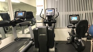 A gym with treadmills, elliptical machines, and a mirrored wall. - Beautiful Remodeled West Los Angeles condo - Brentwood adjacent.  (Los Angeles)