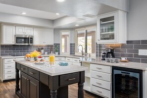 Enjoy cooking in this well-equipped kitchen with a central island, microwave, and dishwasher.