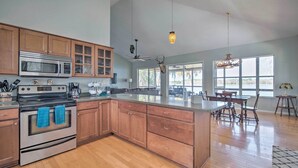 A spacious kitchen with wooden cabinets, stainless steel appliances, and a large island. - Waterfront Home w/ Private Dock in Crystal River (Crystal River)