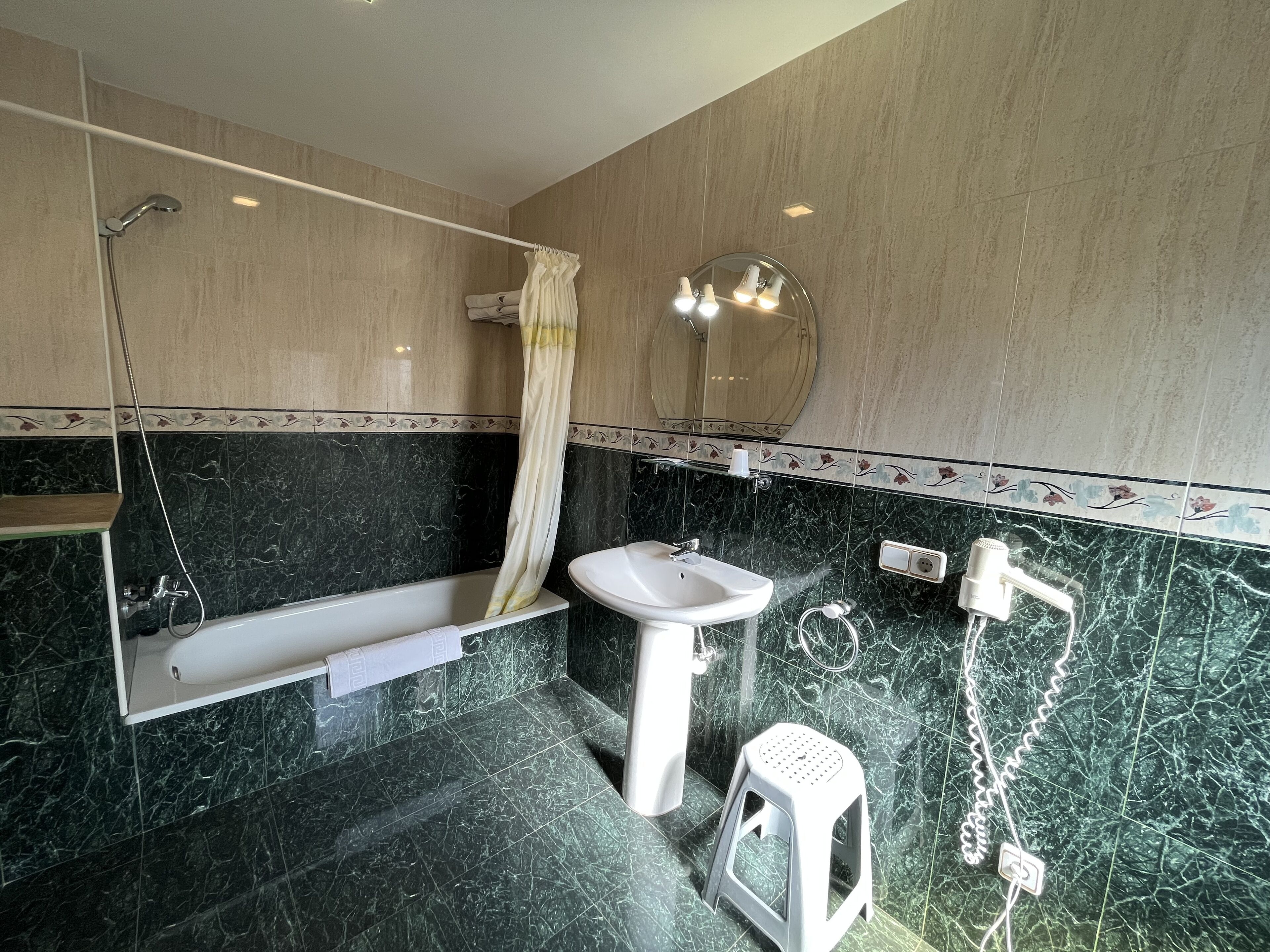 A bathroom with a bathtub, a sink, and a shower.