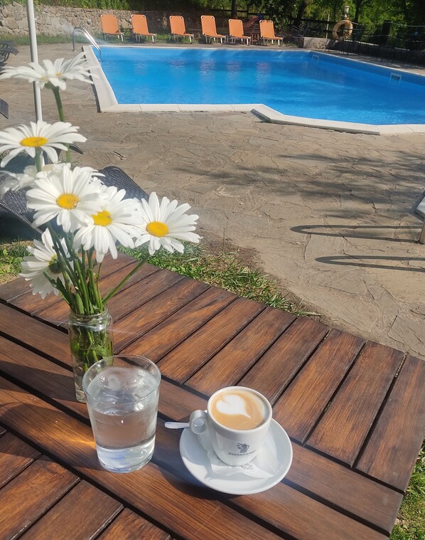 Seasonal outdoor pool, open 10:00 AM to 7:00 PM, pool umbrellas