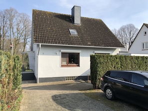 Stylish single-story home with a sloped roof and a charming front entrance.