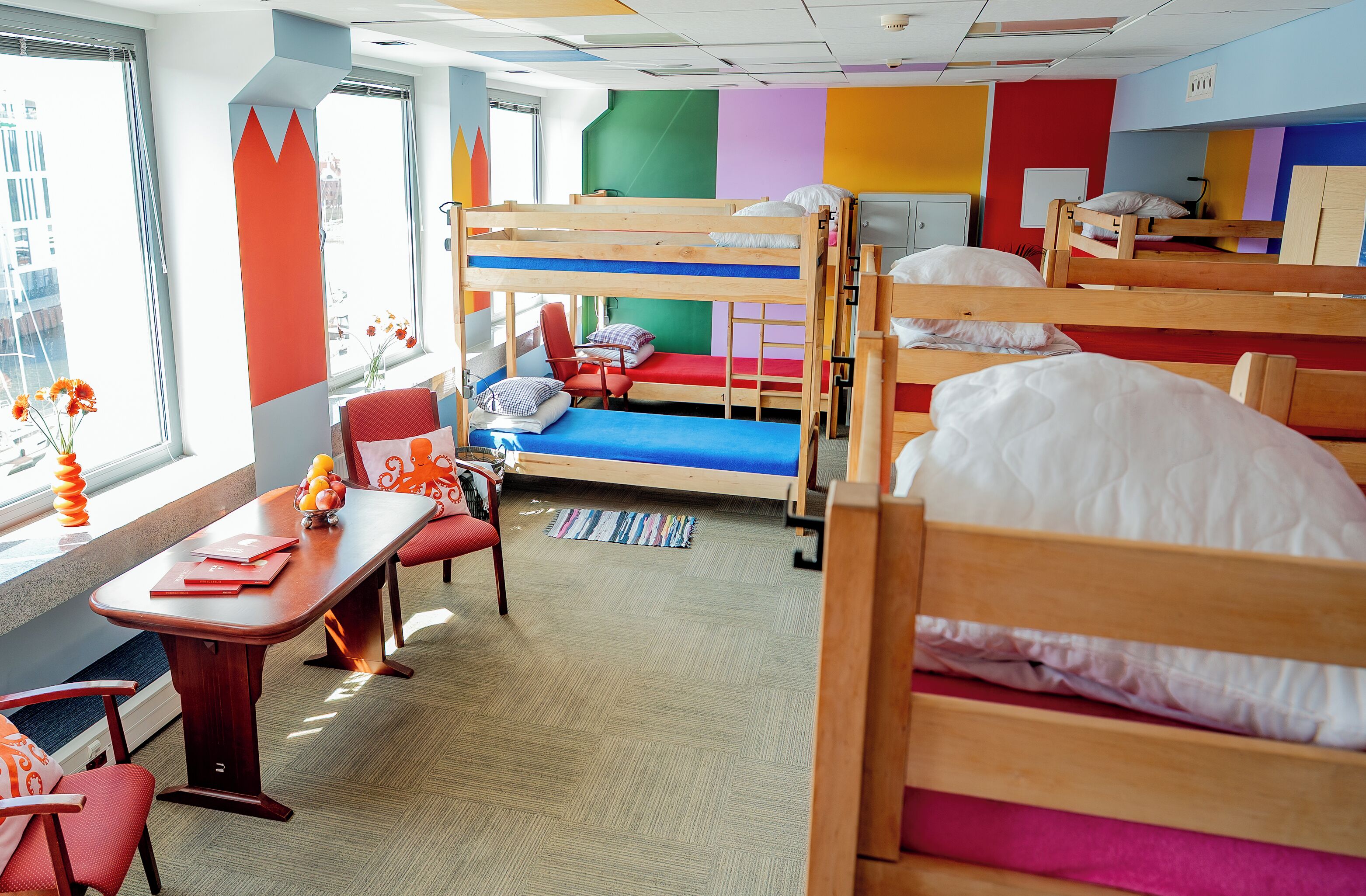 A children's room with bunk beds, a desk, and a chair.