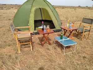 A green tent with a table and chairs set up in a grassy field. - Amanya Double Pitch Tent With Mt Kilimanjaro View (Amboseli)