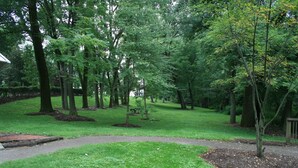 A park with a paved walkway, grassy areas, and trees. - City Boho ✦ New Kitchen ✦ King Bed (Bexley)