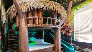 A treehouse bedroom with a slide, a ladder, and a mural of a dog. - Trendy Home w Trampoline RM, Bowling, Fantasy Themed BR & Theater - Near Disney (Davenport)