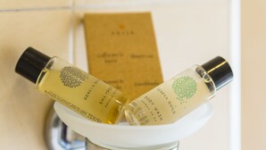 Two bottles of Geneva Guild body wash on a white surface. - BH Napoli Railway - Pistacchio - 4 (Napoli)