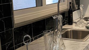 A kitchen with a marble countertop, a stainless steel sink, and a window above the sink. - [A]MOUR AMOUR AMOUR

Lighthouse Views • Walk to Beaches • Classic Bermuda Charm (Hamilton)