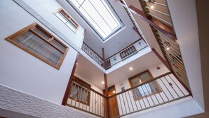 A multi-level interior with balconies, staircases, and skylights. - Estancia San Pedro Hotel (Cusco)