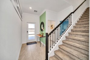 A staircase with a black railing leading to a landing.