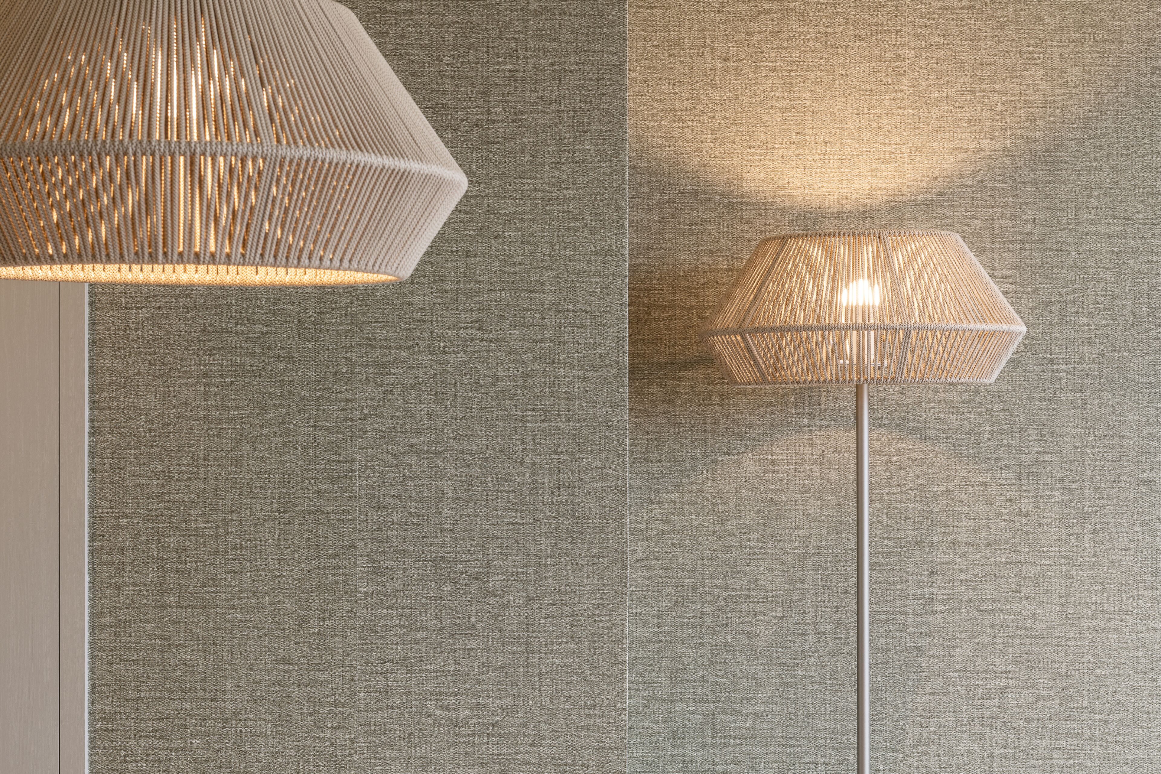 A textured wall with two floor lamps.