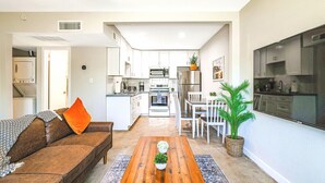 A modern kitchen with white cabinets, a stainless steel refrigerator, and a microwave. - Relaxing Desert Botanical 2 Bedroom In Biltmore (Phoenix)