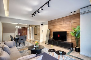 Deluxe Apartment, River View | Living area | TV