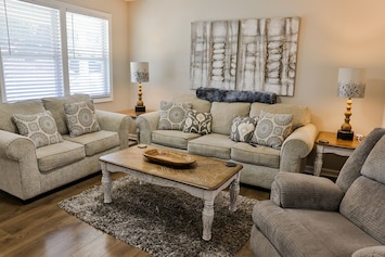 Nice living room with a couch, loveseat and a recliner.