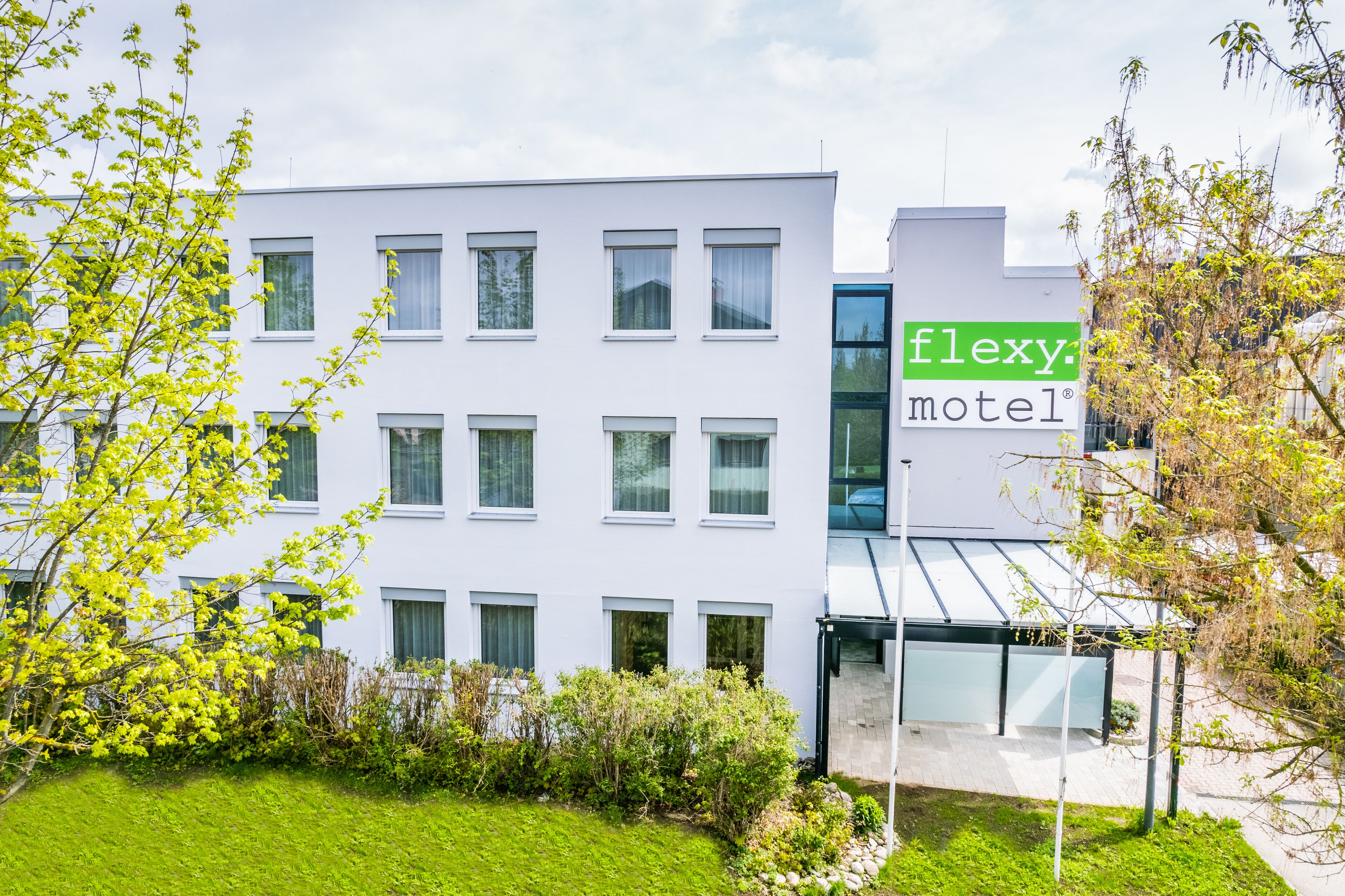A modern building with a sign for 'flexy motel'.